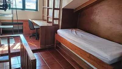a bed in a room with a desk and a desk at Fabulous Antero De Quental in Porto