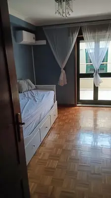 a bedroom with a bed and a large window at Fabulous Antero De Quental in Porto