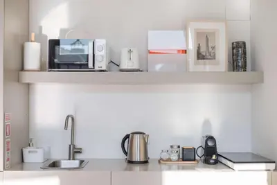 a kitchen counter with various appliances on a counter top at Liiiving in Porto - Design Palace Studio in Porto