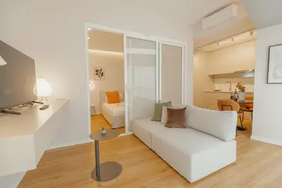 a living room with a white couch and a table at Bright Window Apartment by Vacationy in Porto