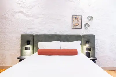 a bedroom with a white bed with a red pillow at Bainharia 82 by LovelyStay in Porto