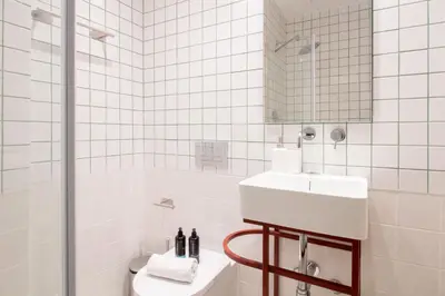 a white bathroom with a sink and a toilet at Bainharia 82 by LovelyStay in Porto