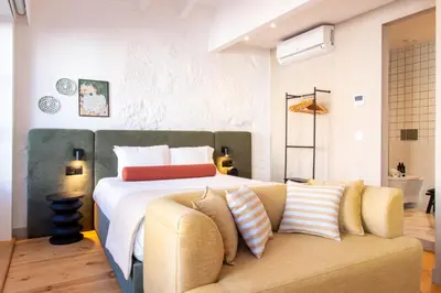a bedroom with a large bed and a couch at Bainharia 82 by LovelyStay in Porto