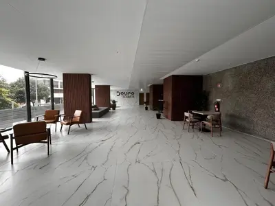 a lobby with a marble floor and tables and chairs at New Douro Tower 305 with shared pool and parking in Vila Nova de Gaia