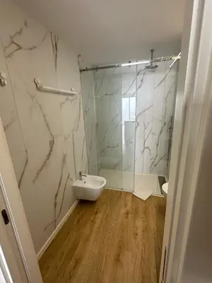 a bathroom with a shower and a toilet and a sink at New Douro Tower 305 with shared pool and parking in Vila Nova de Gaia