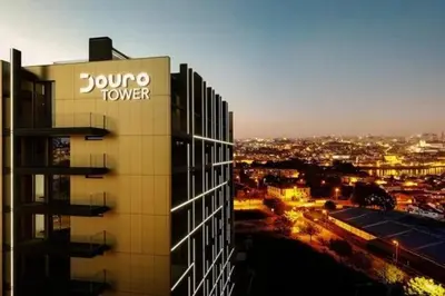 a building with a sign on the side of it at New Douro Tower 206 with shared pool and parking in Vila Nova de Gaia