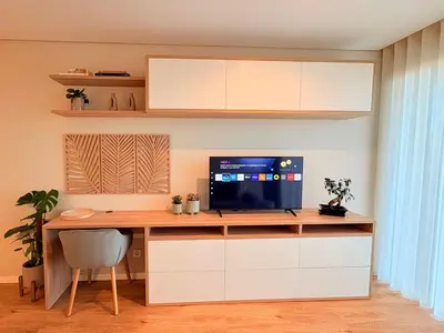 an office with a desk with a tv and a computer at New Douro Tower 206 with shared pool and parking in Vila Nova de Gaia