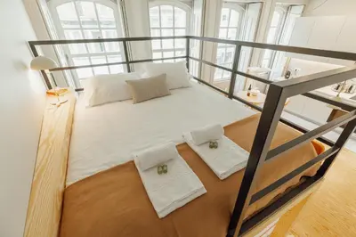 a loft bed with two white pillows on it at Deluxe Studio by Hosty in Porto