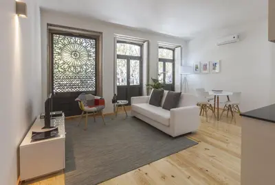 a living room with a white couch and a table at BO - Marquês Apartments in Porto