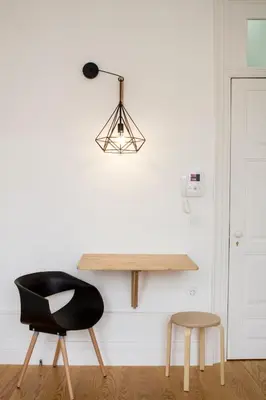 a black chair and a table and stool in a room at Porto Pacific - Almeida Garrett - estúdio a 5 minutos da Ribeira in Porto