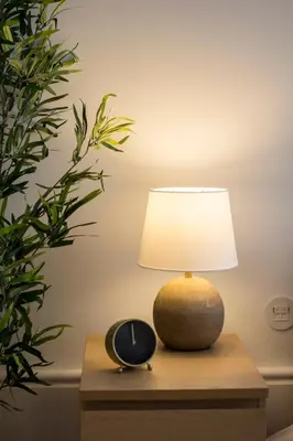 a lamp sitting on a table next to a clock at Porto Pacific - Almeida Garrett - estúdio a 5 minutos da Ribeira in Porto