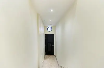 a hallway with a black door and a clock on a wall at GuestReady - Peaceful haven in Porto in Porto