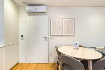 a room with a table and chairs and a door at GuestReady - Peaceful haven in Porto in Porto