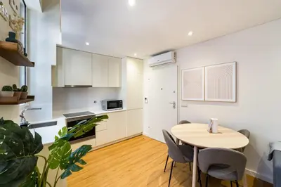 a kitchen and dining room with a table and chairs at GuestReady - Peaceful haven in Porto in Porto