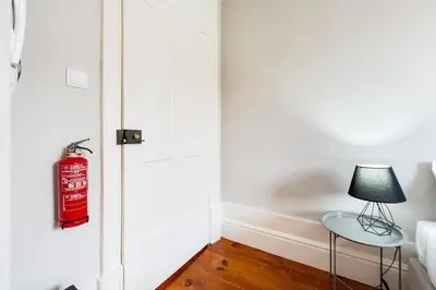 a room with a fire hydrant next to a door at GuestReady - Cosme Heritage Apartments in Porto