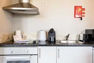 a kitchen counter with a sink and a stove at GuestReady - Cosme Heritage Apartments in Porto