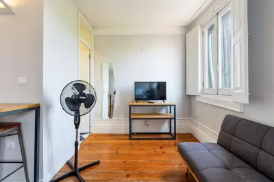 a living room with a couch and a television at GuestReady - Cosme Heritage Apartments in Porto