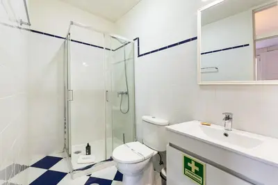 a bathroom with a shower and a toilet and a sink at GuestReady - Cosme Heritage Apartments in Porto