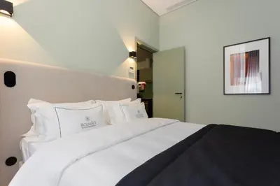 a bedroom with a white bed with white pillows at Bolhão Luxury Apartments in Porto