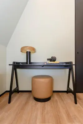 a black desk with a brown chair and a table at Bolhão Luxury Apartments in Porto