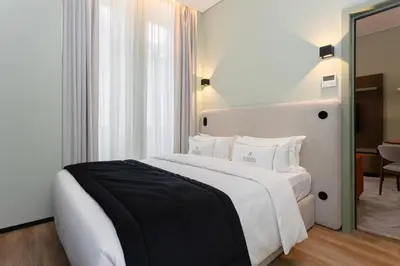 a bedroom with a large white bed with white pillows at Bolhão Luxury Apartments in Porto