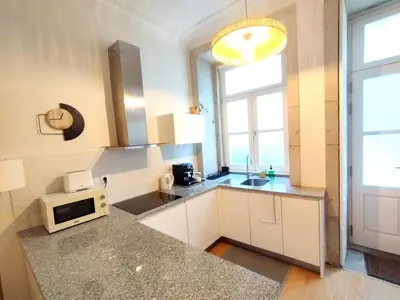 a kitchen with white cabinets and a microwave on a counter at Elegant duplex, WiFi, Porto center in Porto