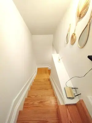 a room with a staircase with a lamp and a book at Elegant duplex, WiFi, Porto center in Porto