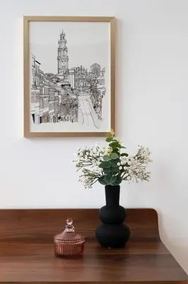 a black vase sitting on a table with a plant at Bonjardim Signature Apartment 4B in Porto
