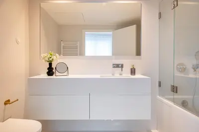 a white bathroom with a sink and a mirror at Bonjardim Signature Apartment 4B in Porto