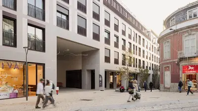 a group of people walking down a street in front of a building at Bonjardim Signature Apartment 4B in Porto