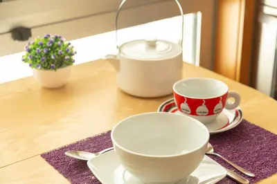two cups and saucers sitting on a table at Francos Relaxing Apartment by the metro in Porto