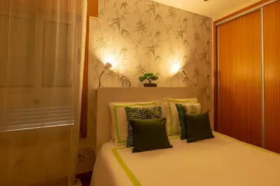 a bedroom with a bed with green pillows at Francos Relaxing Apartment by the metro in Porto