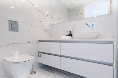 a white bathroom with a sink and a toilet at Aires Ornelas Gem, City Escape with Private Parking in Porto