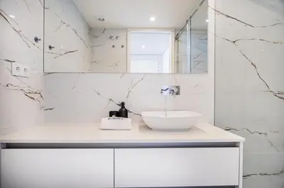a white bathroom with a sink and a mirror at Aires Ornelas Gem, City Escape with Private Parking in Porto
