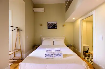 a bedroom with a bed with two pillows on it at Photography Apartments in Porto