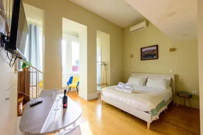 a bedroom with a bed and a table and a tv at Photography Apartments in Porto