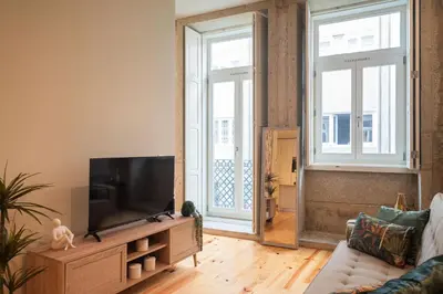 a living room with a television and a couch at Luxury Style 10 with AC Downtown Porto near Metro in Porto