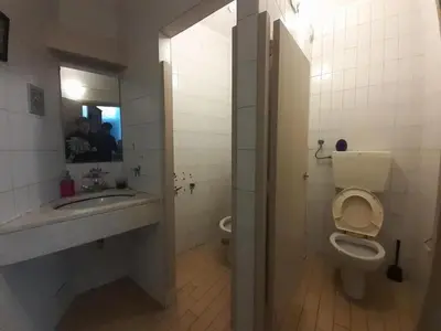 a bathroom with a toilet and a sink and a mirror at Porto Central Hostel in Porto