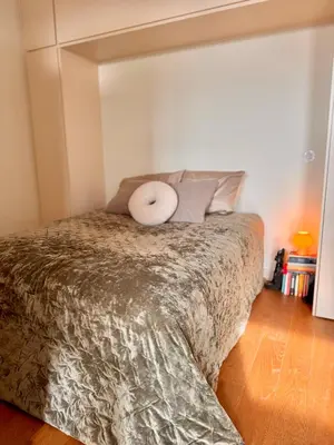 a bedroom with a bed with a white pillow on it at Bonfim cozy apartment Porto in Porto
