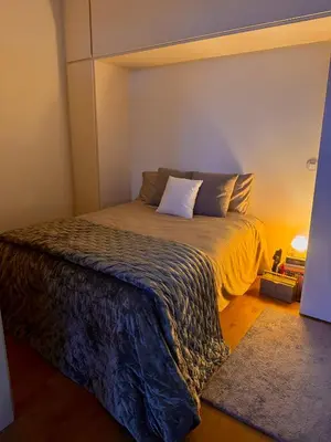 a bedroom with a large bed with a yellow blanket at Bonfim cozy apartment Porto in Porto