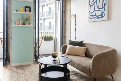 a living room with a couch and a table at Studio Apartment Torrinha in Porto