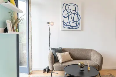 a living room with a couch and a table at Studio Apartment Torrinha in Porto