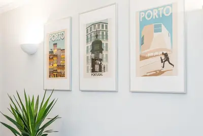 four framed posters on a wall with a plant at GuestReady - Charming Cozy Getaway in Porto in Porto