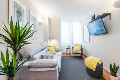 a living room with a couch and a tv at GuestReady - Charming Cozy Getaway in Porto in Porto