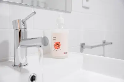 a bottle of detergent sitting on a bathroom sink at GuestReady - A fantastic home in Porto in Porto