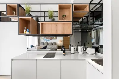 a kitchen with a white counter top and wooden cabinets at GuestReady - Alma Invicta in Porto