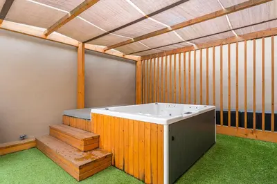 a jacuzzi tub in a room with green grass at GuestReady - Alma Invicta in Porto
