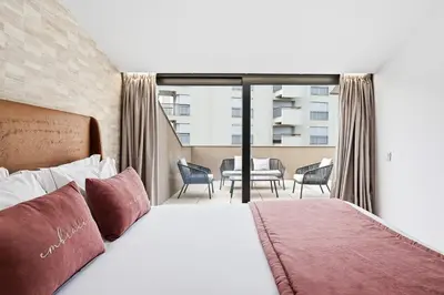 a hotel room with a bed and a balcony at GuestReady - Alma Invicta in Porto