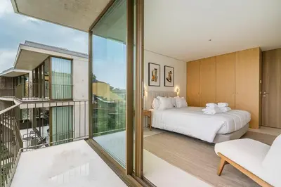 a bedroom with a bed and a balcony at GuestReady - DPV Residences in Porto