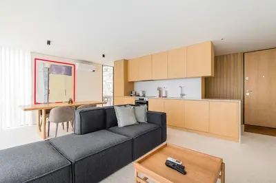 a living room with a couch and a kitchen at GuestReady - DPV Residences in Porto
